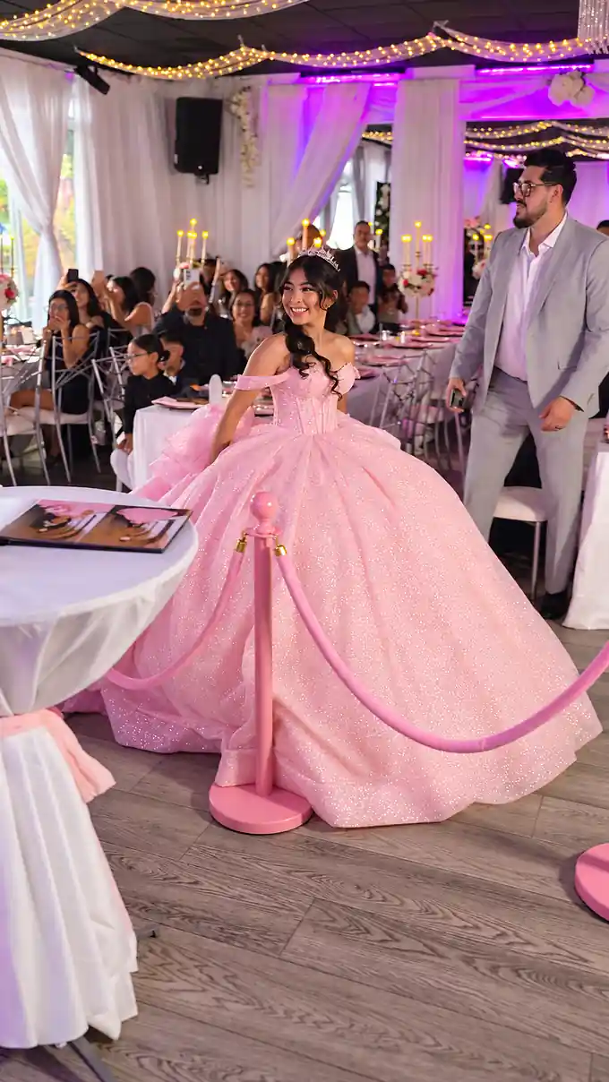 Quinceañera in a pink gown making her entrance